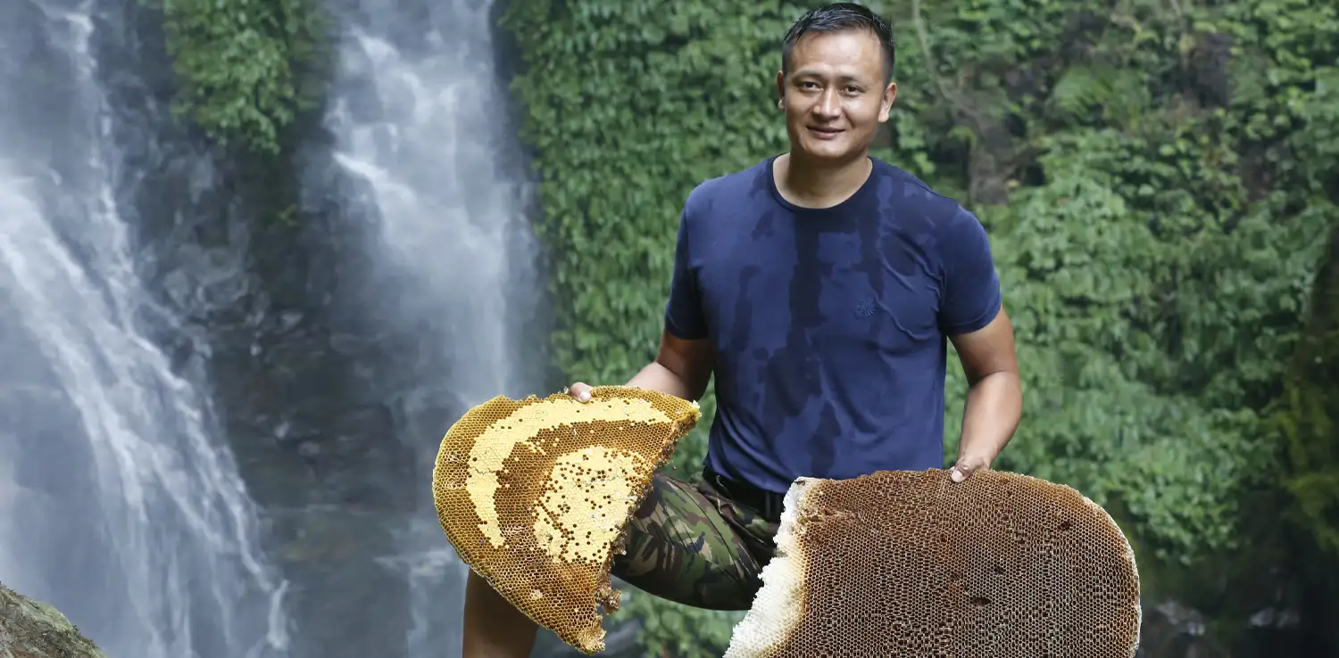 a man holding beehives