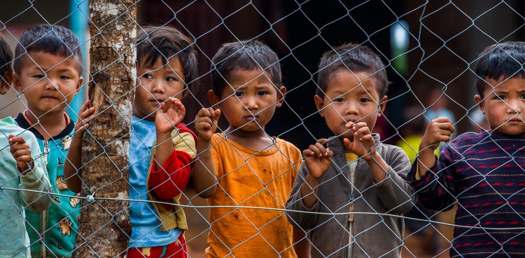 A photo by UNICEF of Myanmar children standing firmly, commemorating 70 years delivering for children