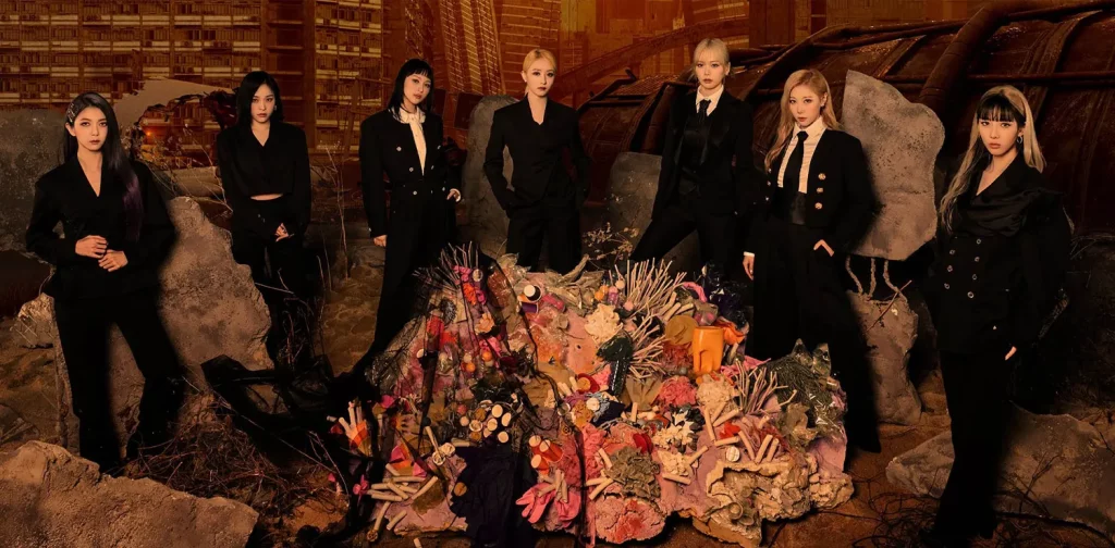 seven women members of dreamcatcher standing around a sculpture of sea anemone made of plastic