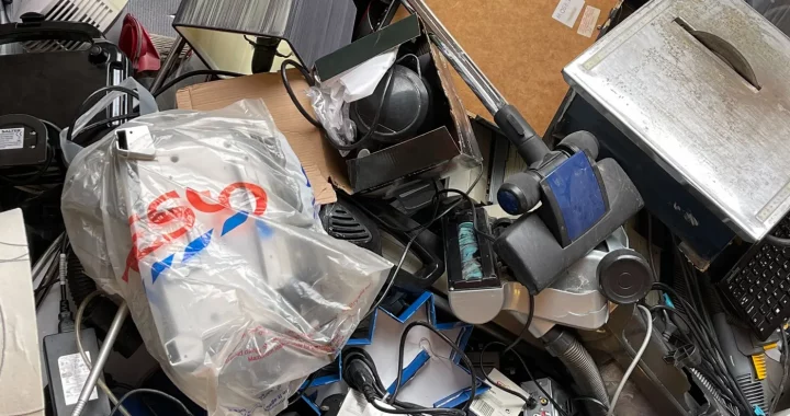 pile of electronic waste such as cables, keyboards, and other electrical appliances