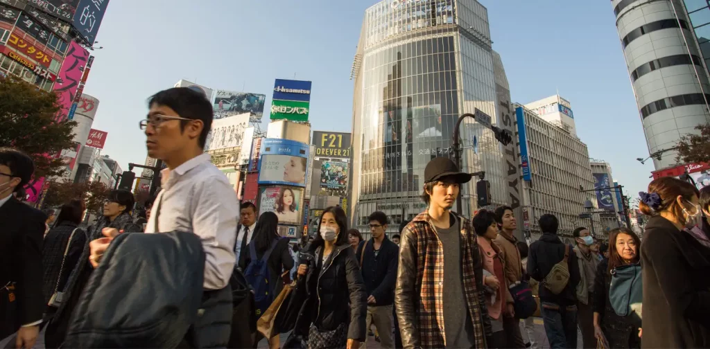 busy people walking with big buildings on the background