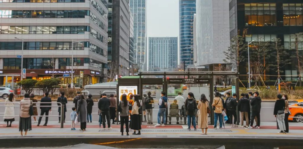 people waiting at a bus stop