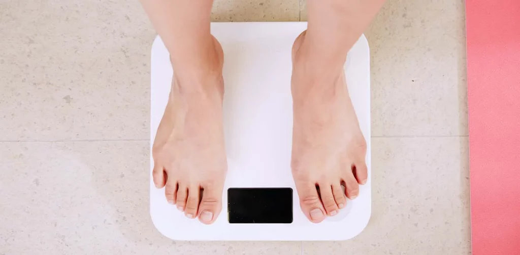 a person standing on weight scale