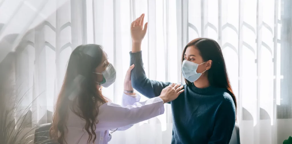 a female doctor is examining a female patient