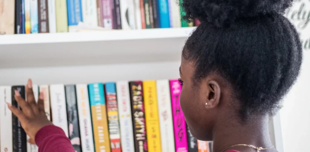 a girl browsing through bookshelves