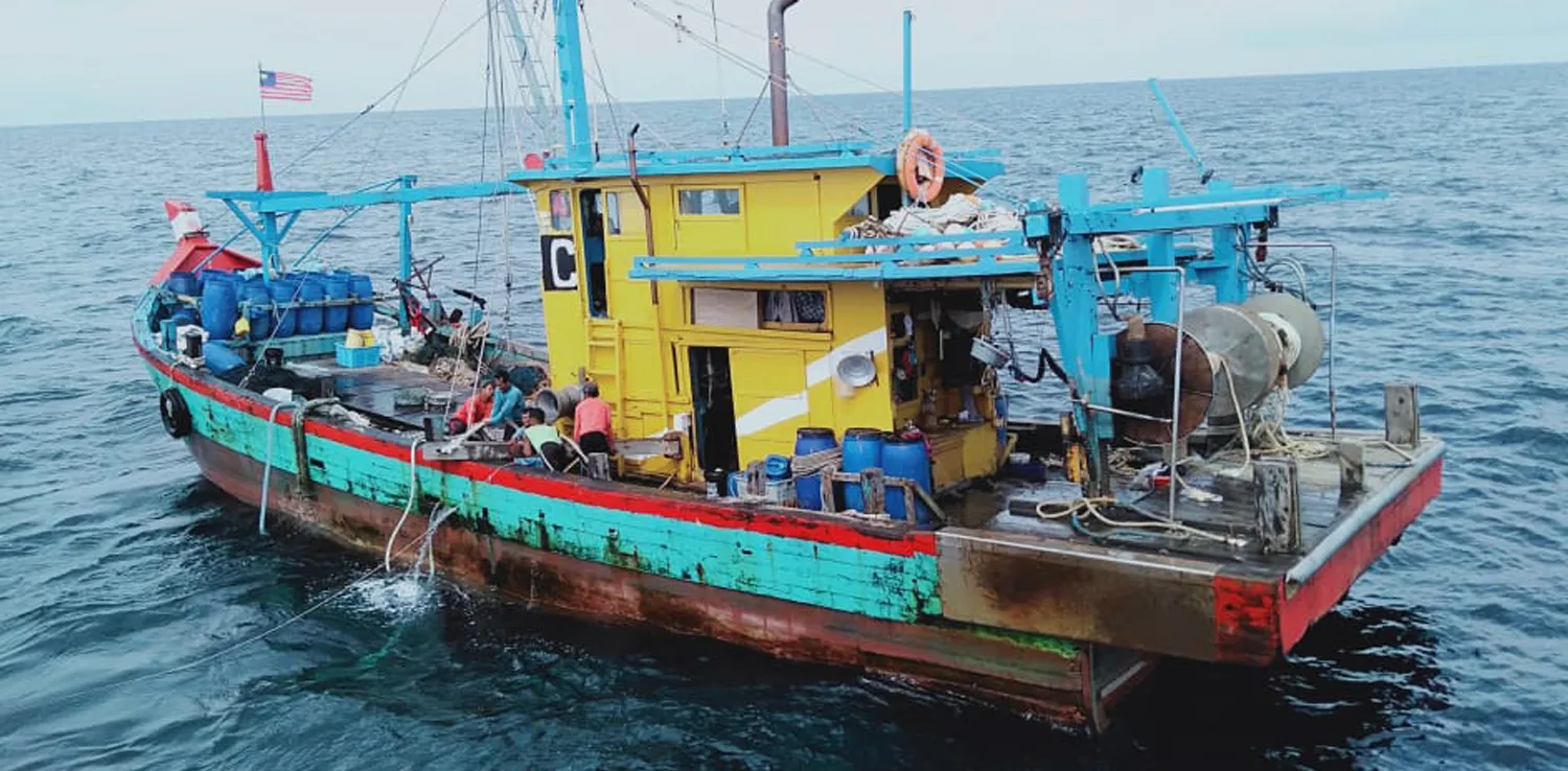 a green ship in the ocean