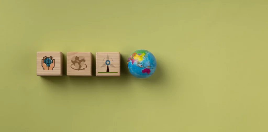 three wooden blocks with illustrations and one globe