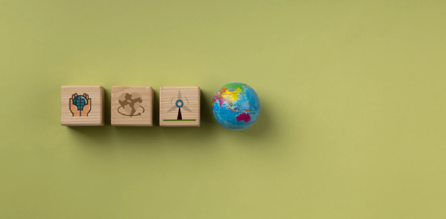 three wooden blocks with illustrations and one globe