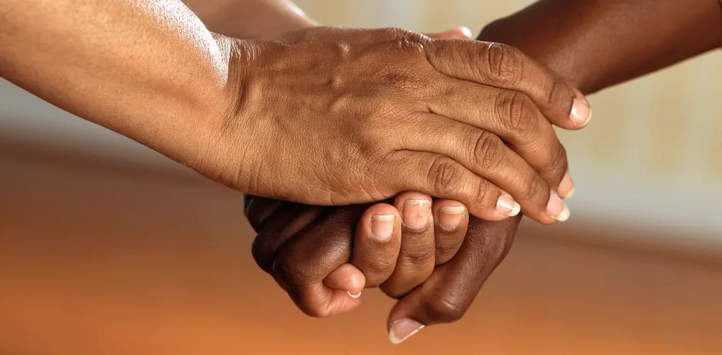 two persons holding hands