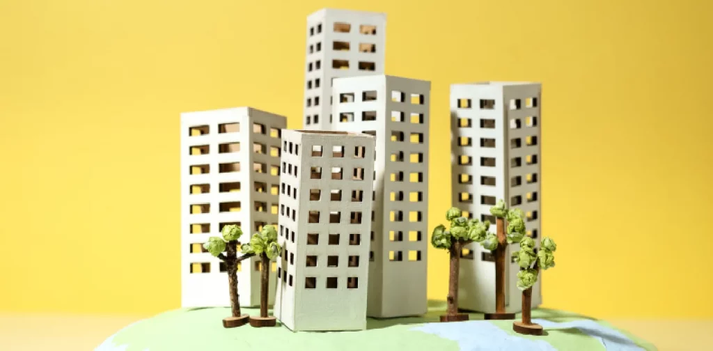 paper figures of buildings, tress, and globes