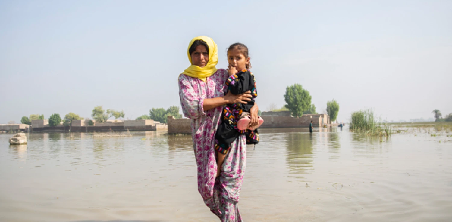 A woman with a child on her hip