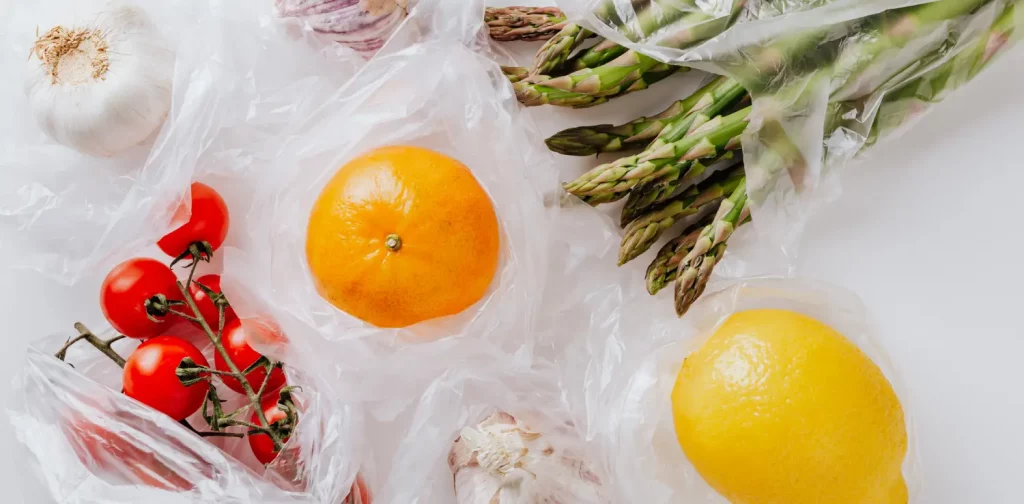 various fruits and vegetables in plastic produce bags