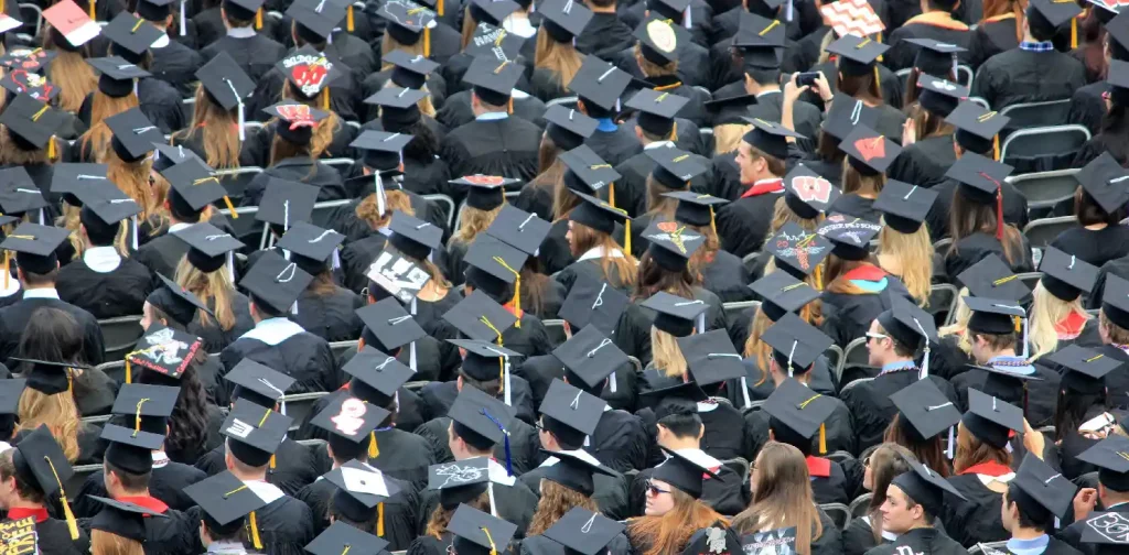 aerial shot of a crowd of young people in graduation caps