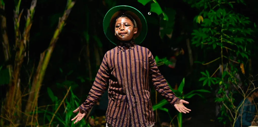 a boy in costume as a character at the food sovereignty theater stage