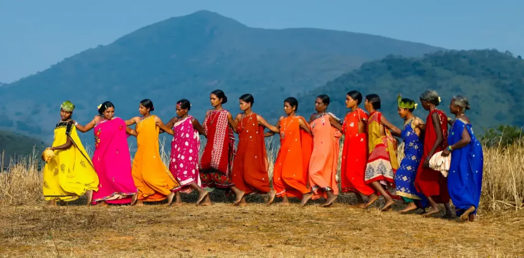 a line of indigenous women at a field