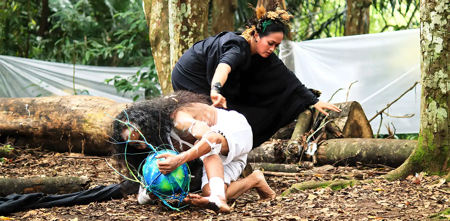 a woman, Lena Guslina, is performing with male dancer in a forest