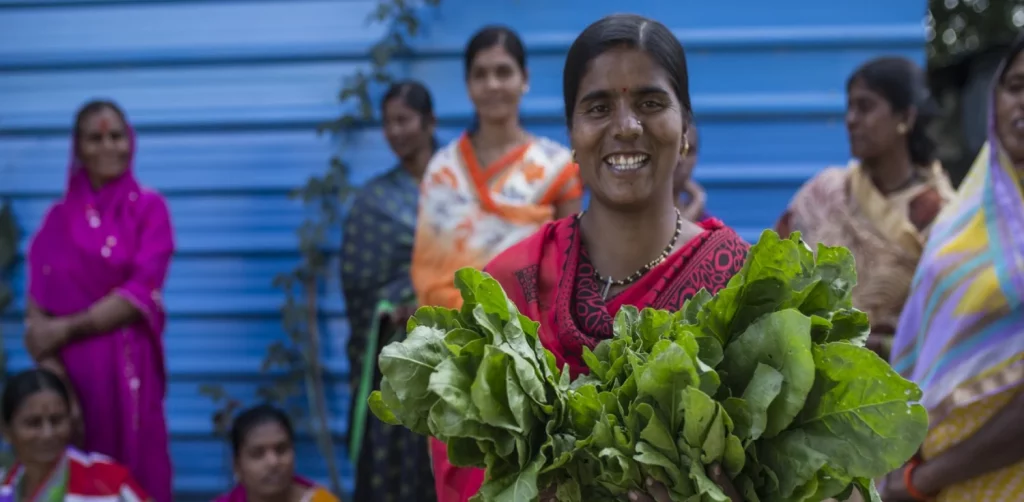 women holding and selling their produce at the market