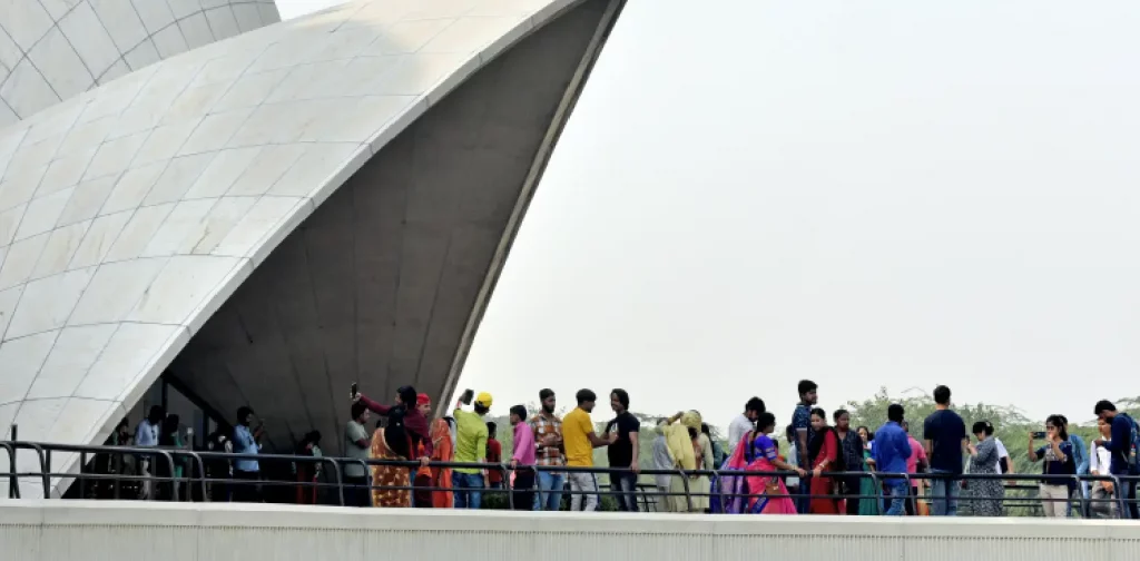 a group of people are waiting in line to enter a tourist attraction in India