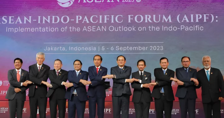 ten men clad in suits, ASEAN Member State leaders, are holding hand to show solidarity