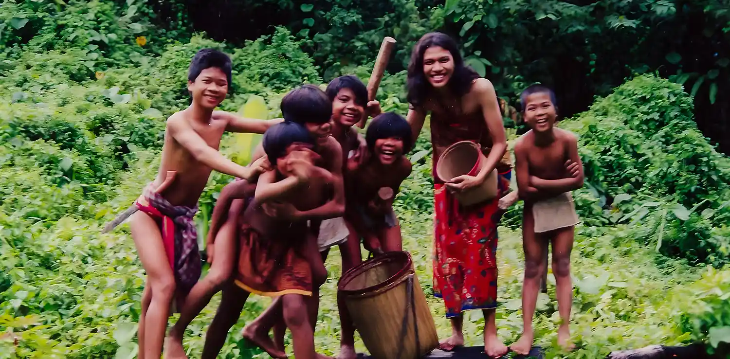 A woman, butet manurung, with children in the forest