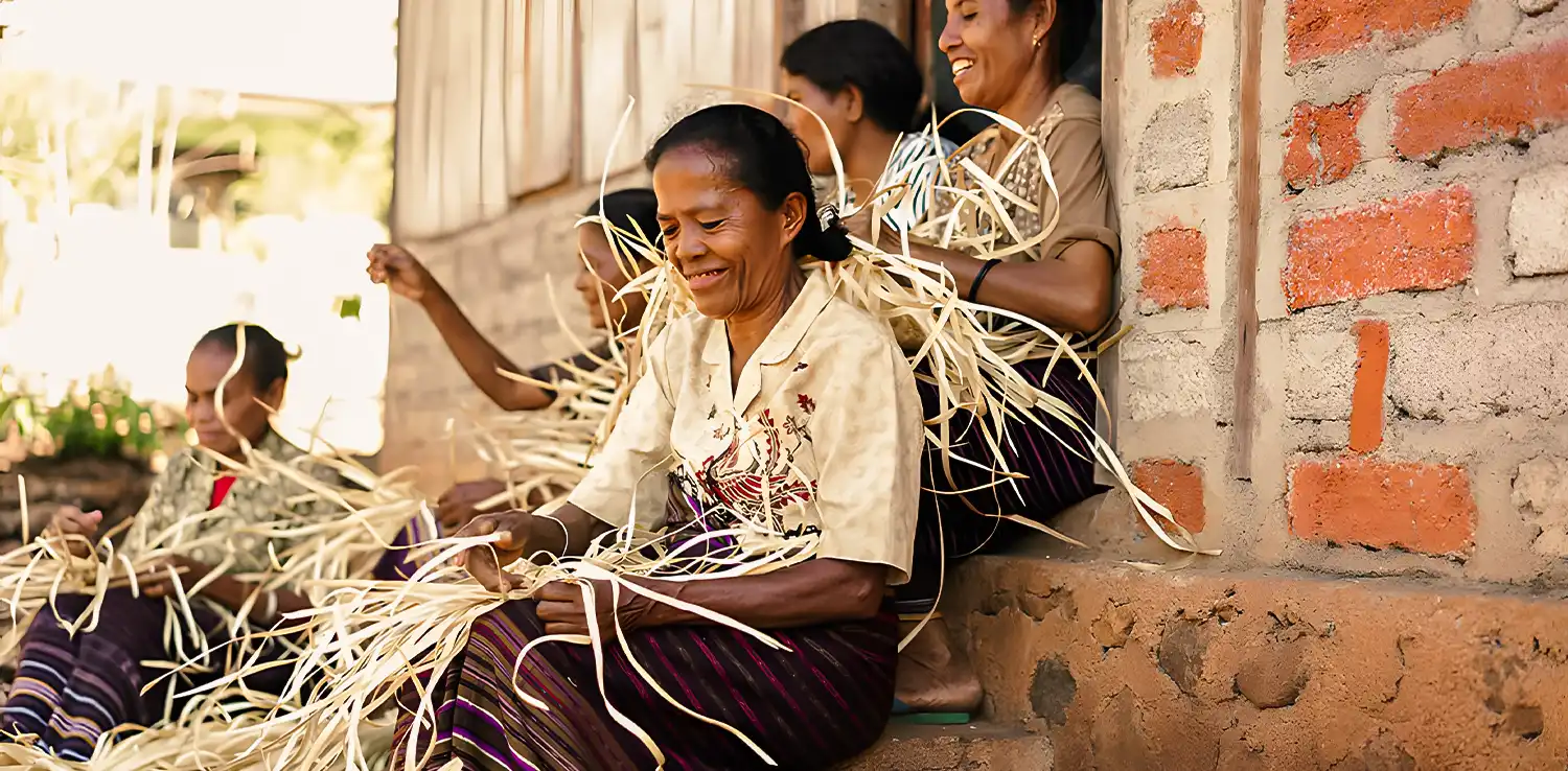 women of East Nusa Tenggara sitting down at stairs and weaving