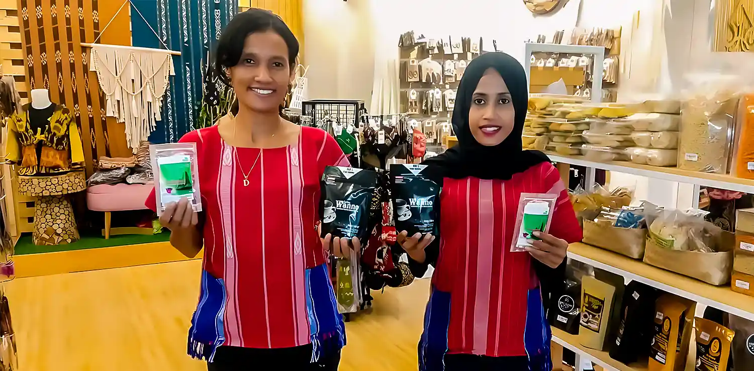 two women are showing tea and coffee products