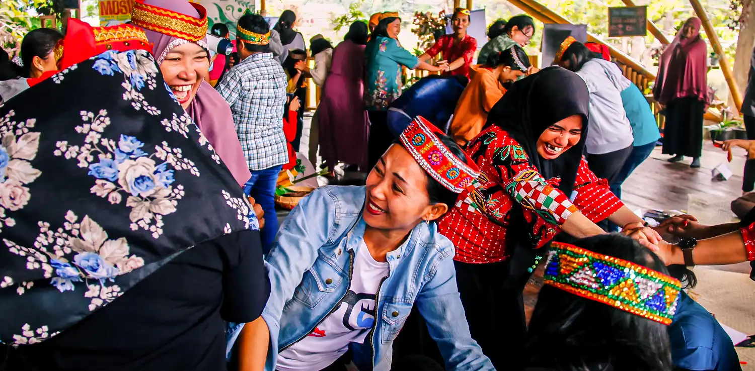 several women wearing headbands are playing and laughing together.