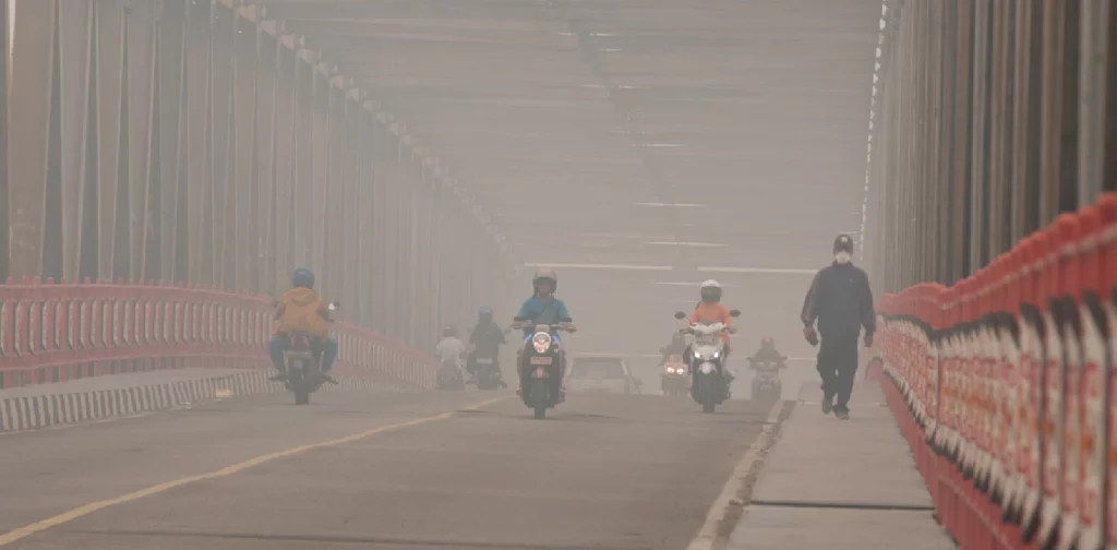 hazy air on a bridge with several motorbikes
