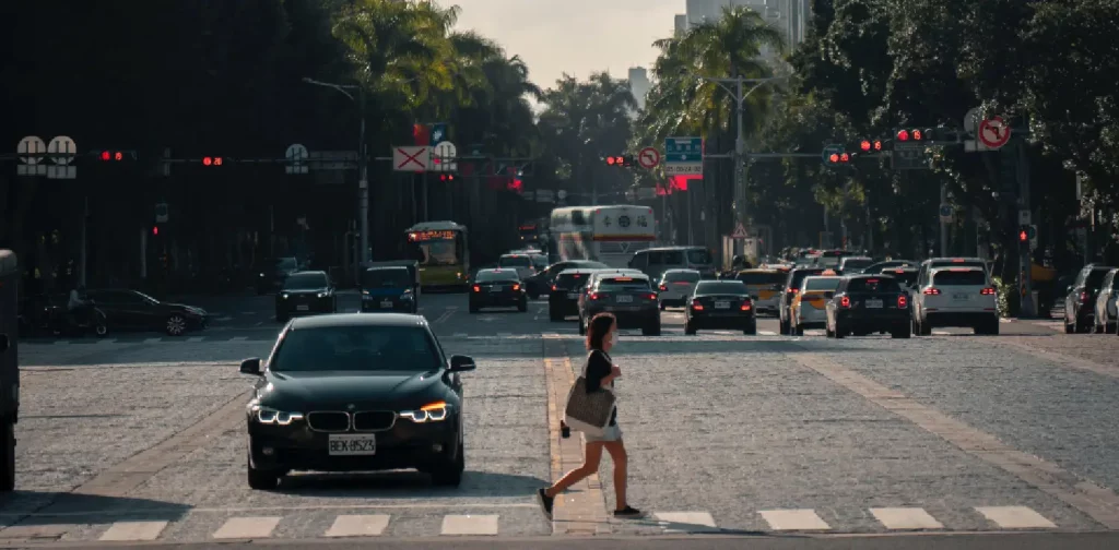 a woman crossing a street