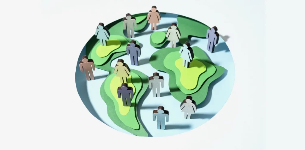 paper cutouts of people on a model of earth