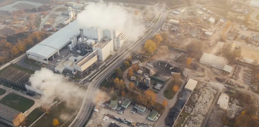 aerial view of thick smoke coming out of a big factory