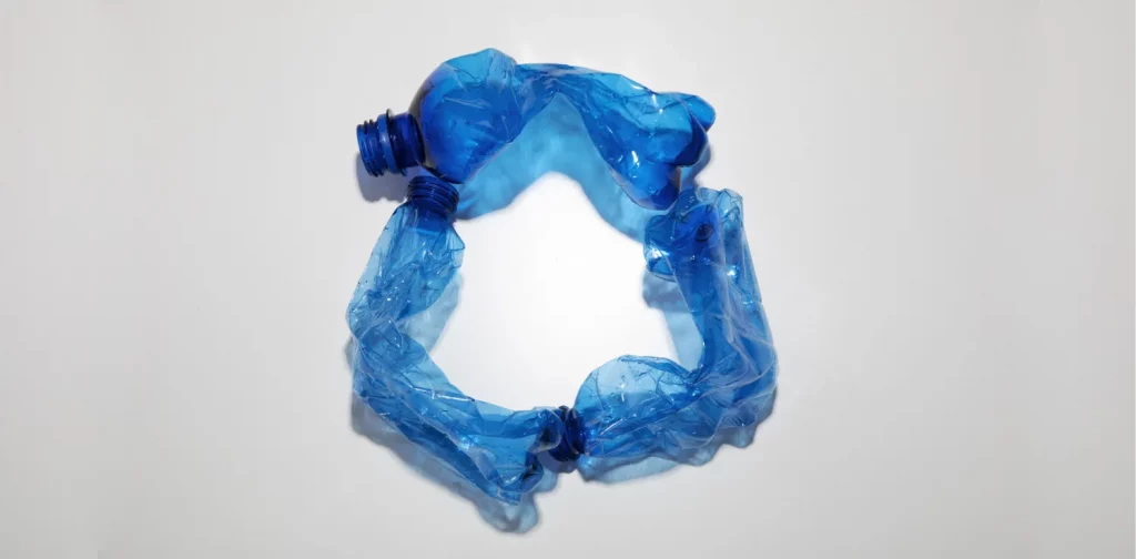 three crushed blue plastic bottle forming a circle
