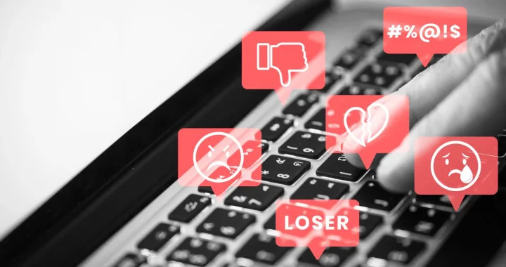 a photo of laptop keyboard with illustration of hate speech in red bubbles