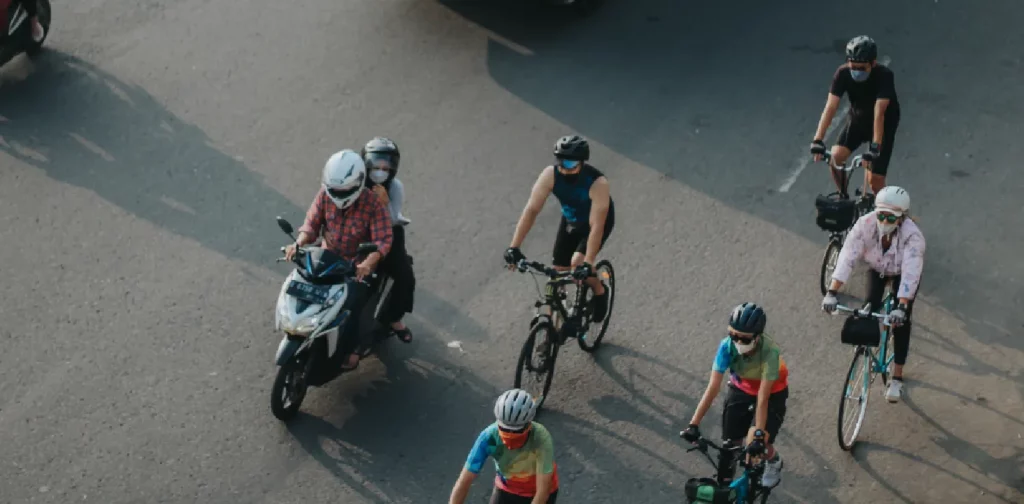 several cyclists sharing lanes with motor vehicle