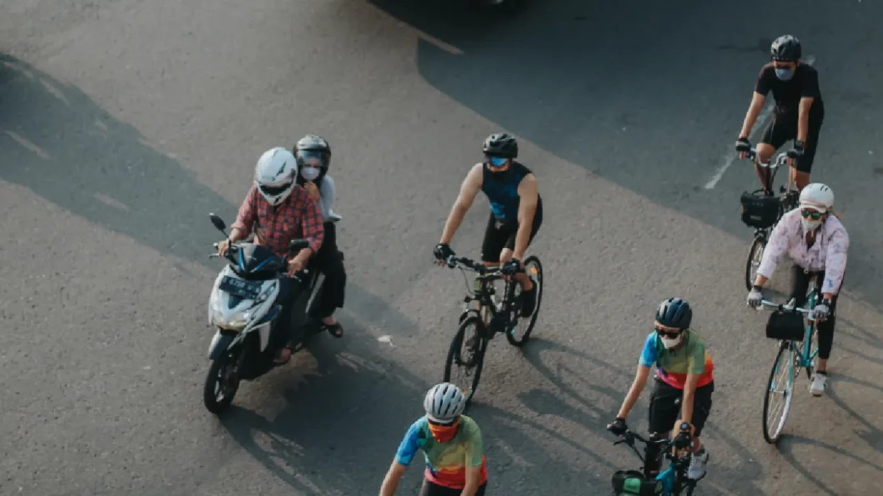 several cyclists sharing lanes with motor vehicle