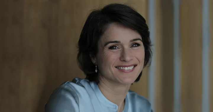 a woman in short hair wearing white
