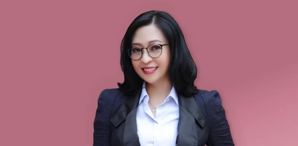 a woman in glasses and a suit