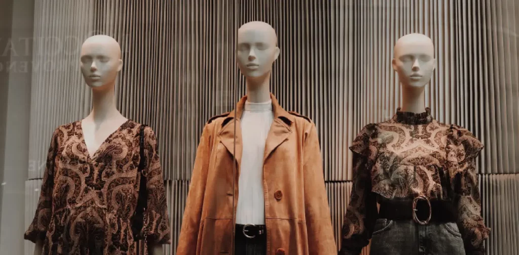 three mannequins wearing brown outfits