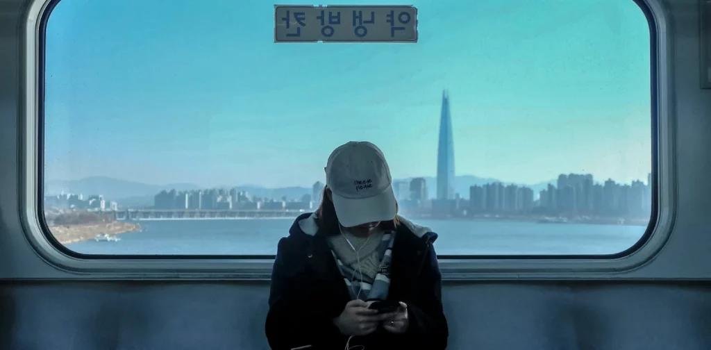 a woman in a cap sitting in a train