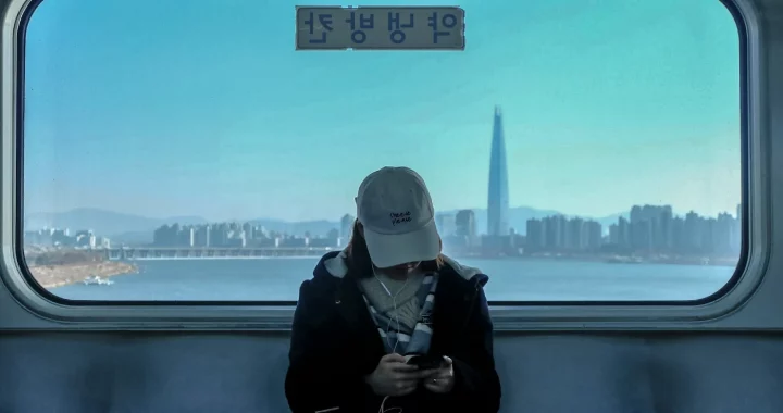 a woman in a cap sitting in a train