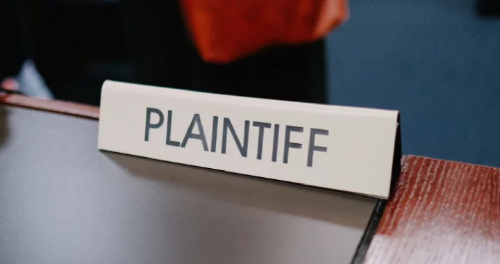 close-up photo of a table sign with the word “PLAINTIFF” written on it