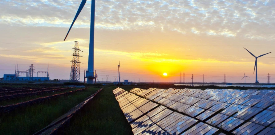 Wind turbines and solar panels on field