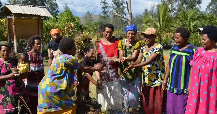 A group of Papua New Guinean women surrounding water source