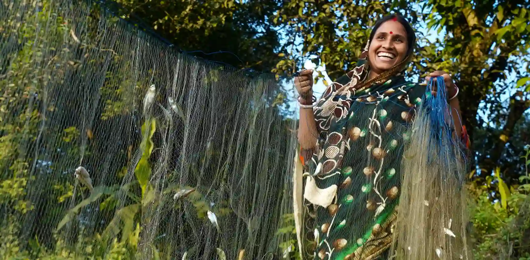 Indian woman holding a fish net