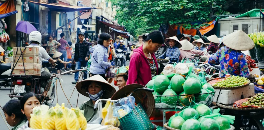women street vendors and buyers on the side of a street