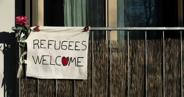 a sign saying refugees welcome