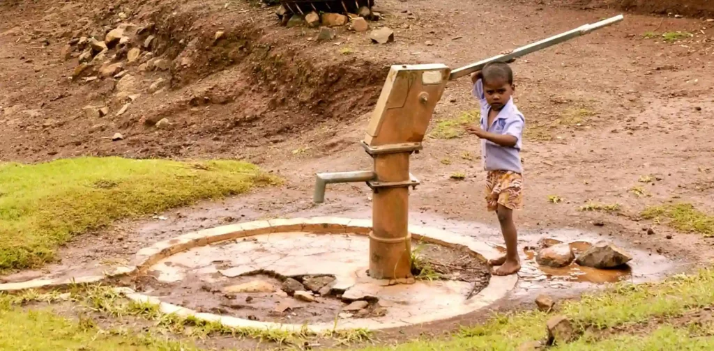 child drawing water from source