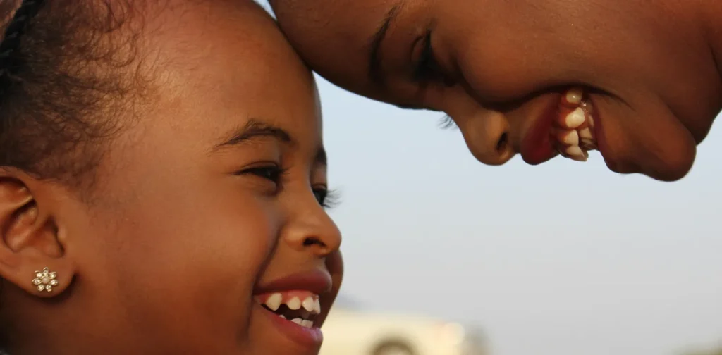 a close up of two smiling young girls