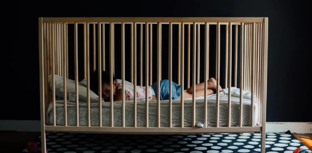 a toddler inside a crib