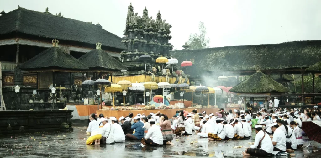 a group of people conducting traditional rituals in a temple